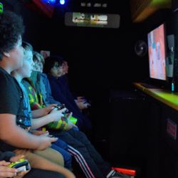 Rolling Video Games of New England - The inside of rolling video games of New England game van with children playing video games.