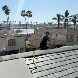 Tweedy Plumbing & Restoration - Clearing drain stoppage from the roof vent.