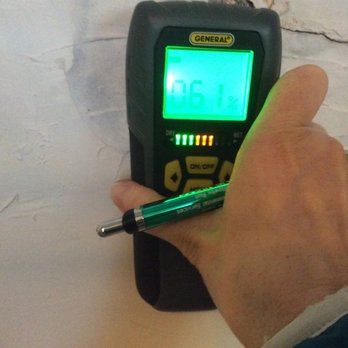 Accurate Inspects - Checking for moisture with one of our moisture meters. - Home Inspectors Near Me