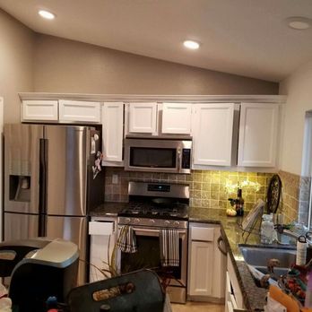 Blue Man Remodeling - a kitchen with stainless steel appliances - Painters Near Me Blue Man Remodeling - a kitchen with stainless steel appliances - Painters Near Me