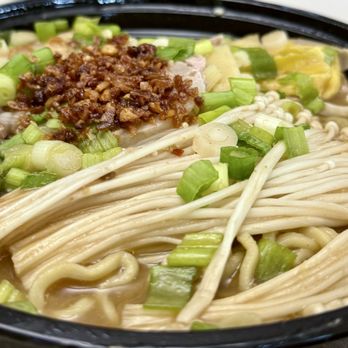LAX Grille - Miso Ramen - The image shows a bowl of miso ramen with thin noodles submerged in broth. Toppings include chopped green onions, bean sprouts, and a portion of minced meat or seasoned ground meat. The ingredients are arranged in a way that highlights the fresh vegetables and savory toppings typical of Asian-inspired ramen dishes. - Ramen Near Me - La Crosse, Wisconsin