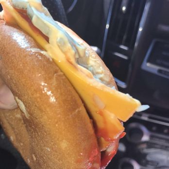McDonald's - a person holding a sandwich in their hand - Burgers Near Me - Burlington, Iowa McDonald's - a person holding a sandwich in their hand - Burgers Near Me - Burlington, Iowa