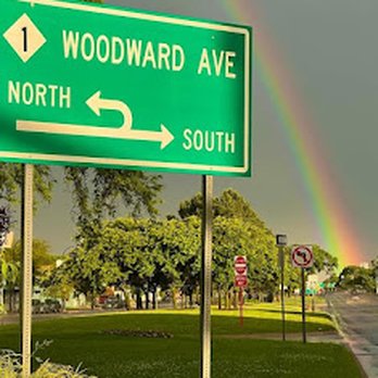 Rainbow Liquor - a rainbow in the distance and a street sign in the foreground - Beer, Wine & Spirits Near Me - Ferndale, Michigan