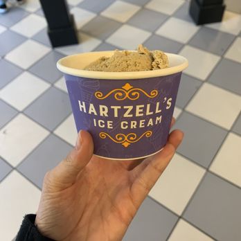Hartzell's - a hand holding a cup of ice cream - Ice Cream & Frozen Yogurt Near Me - Bloomington, Indiana
