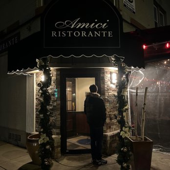 Amici Ristorante - a man standing in front of a restaurant - Italian Near Me - Kenmore, New York Amici Ristorante - a man standing in front of a restaurant - Italian Near Me - Kenmore, New York