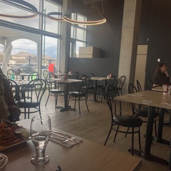 Cafe Cognac - a woman sitting at a table - Breakfast & Brunch Near Me - Gatineau, Quebec