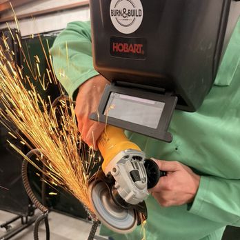 Burn and Build Studios - Person using a grinder on project. - Specialty Schools Near Me - Cocoa, Florida