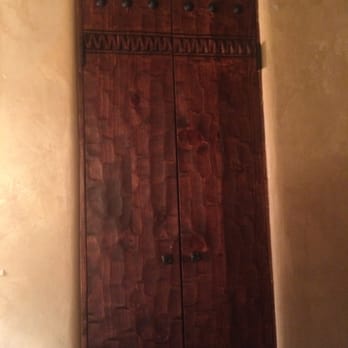 Antigua Inn - Looks like a closet, but they're hand-crafted doors leading you to your bathroom. - Hotels Near Me - Santa Fe, New Mexico