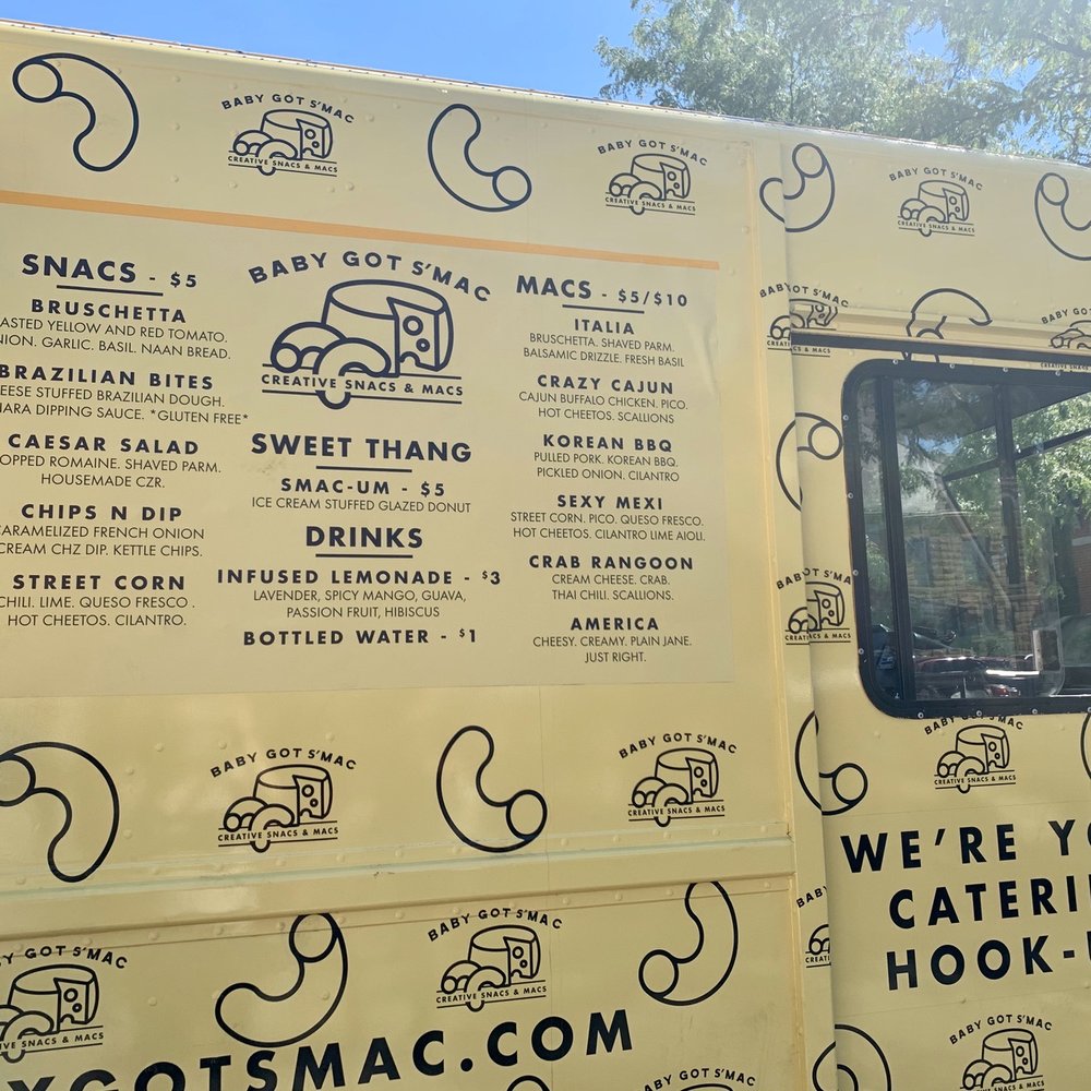 a woman looking out the window of a food truck a woman looking out the window of a food truck