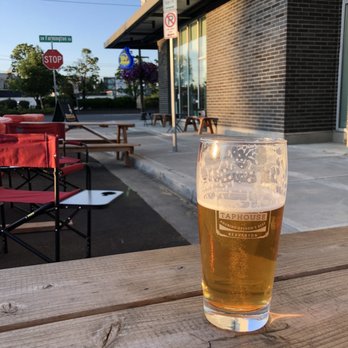 Raindrop Tap House - a glass of beer on a table - Bars Near Me - Beaverton, Oregon