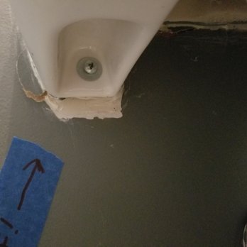 Empire Today - Spot where toggle bolt was pulled through the wall. Sink was left this way by installer. - Carpet Installation Near Me Empire Today - Spot where toggle bolt was pulled through the wall. Sink was left this way by installer. - Carpet Installation Near Me