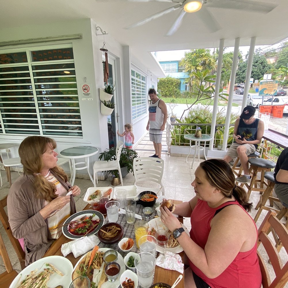 Passiflora - Family partaking in all the vegan food on the patio outside. - Vegan Near Me - Rincon, Puerto Rico Passiflora - Family partaking in all the vegan food on the patio outside. - Vegan Near Me - Rincon, Puerto Rico