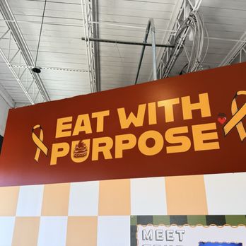 Zeke Smash - Good food for a good cause--the mural encourages us to "eat with purpose" - Hot Dogs Near Me - Wilmington, North Carolina