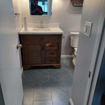 TKT General Contractor - a man taking a picture of a bathroom - General Contractors Near Me TKT General Contractor - a man taking a picture of a bathroom - General Contractors Near Me