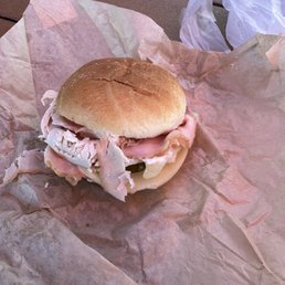 Ham, turkey, pickle, and cheese sandwich. Ham, turkey, pickle, and cheese sandwich.