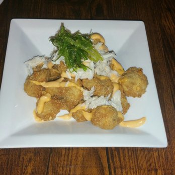 Ricos World Kitchen - Fried mushrooms tossed in blue crab meat and seaweed salad - New American Near Me - Buford, Georgia