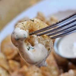 Wasena City Tap Room & Grill - A fork holding a Fried Pork Rind ready to be tasted and savored.