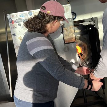 Barrio Glassworks - Jenny is heating the glass after rolling it in colored beads - Art Galleries Near Me - Carlsbad, California Barrio Glassworks - Jenny is heating the glass after rolling it in colored beads - Art Galleries Near Me - Carlsbad, California