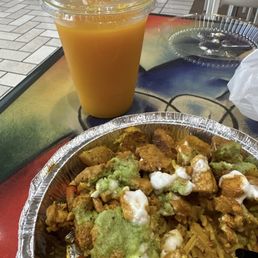 Saffron rice platter with grilled chicken, potatoes, veggies, chick peas, garlic sauce, and chutney, with mango juice Saffron rice platter with grilled chicken, potatoes, veggies, chick peas, garlic sauce, and chutney, with mango juice