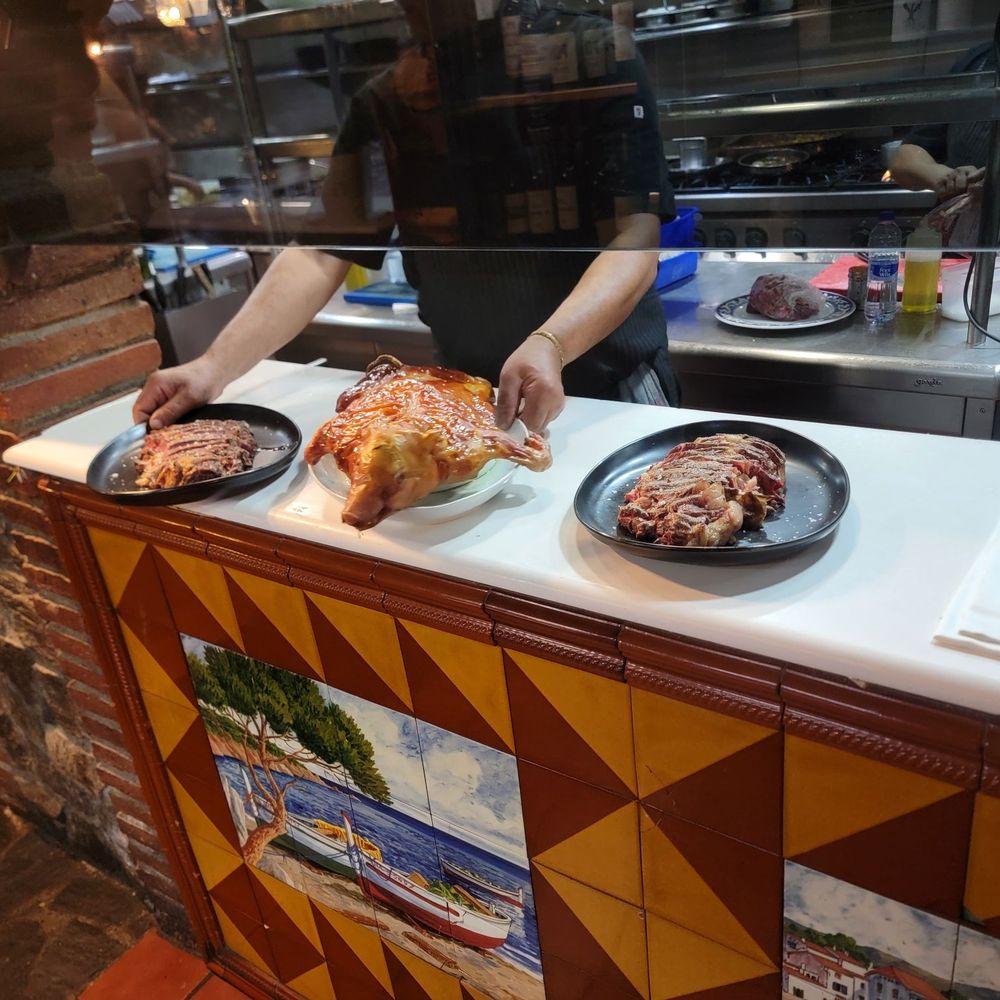 Racó de la Vila - Food coming from the grill. piglet and steak - Spanish Near Me - Barcelona, B Racó de la Vila - Food coming from the grill. piglet and steak - Spanish Near Me - Barcelona, B