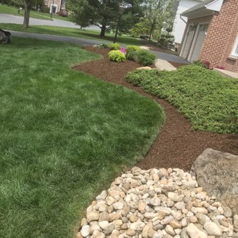 Rob's Lawn Stars - a lawn with rocks and grass - Lawn Services Near Me Rob's Lawn Stars - a lawn with rocks and grass - Lawn Services Near Me
