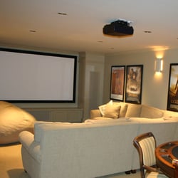 Cutting Edge Design - Custom built surround houses speakers and screen in this great multi-purpose room.