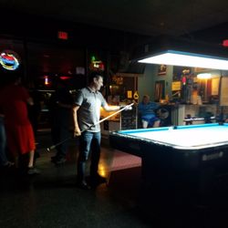 Sheas Fat Cats - People playing pool and pro shop in the background.