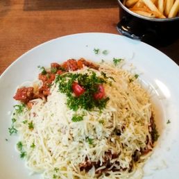 Pasta Bolognese and grilled beef stick with salad and fries Pasta Bolognese and grilled beef stick with salad and fries