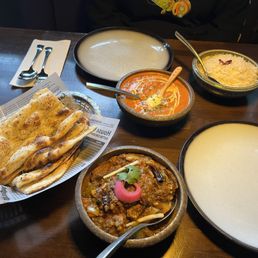 Garlic naan, kadahi lamb, butter chicken, rice Garlic naan, kadahi lamb, butter chicken, rice