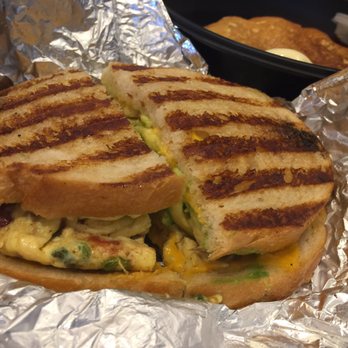Corner Bakery Cafe - The Anaheim panini: scrambled eggs, smoked bacon, tomatoes, onions, avocado & cheddar on the sourdough - Sandwiches Near Me - Irvine, California