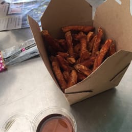 Delicious hot sweet potatoes fries with maple syrup for dipping. Delicious hot sweet potatoes fries with maple syrup for dipping.