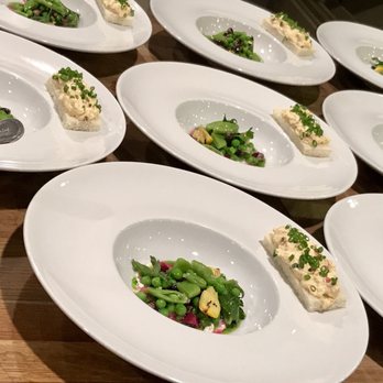SharksTeeth - a number of plates of food on a table - New American Near Me SharksTeeth - a number of plates of food on a table - New American Near Me