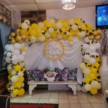 MidDay Restaurant - a decorated stage with balloons and a bench - Venues & Event Spaces Near Me - Los Angeles, California