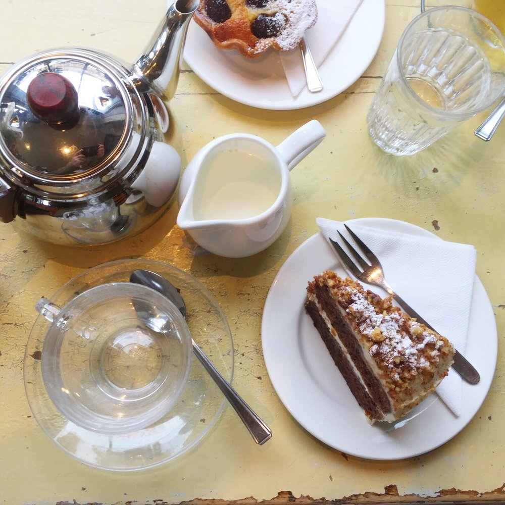 My delicious cake & (un-poured) cup of tea... Rookie Yelper pic error! My pal's tart peeking from the top (not as saucy as it sounds).
