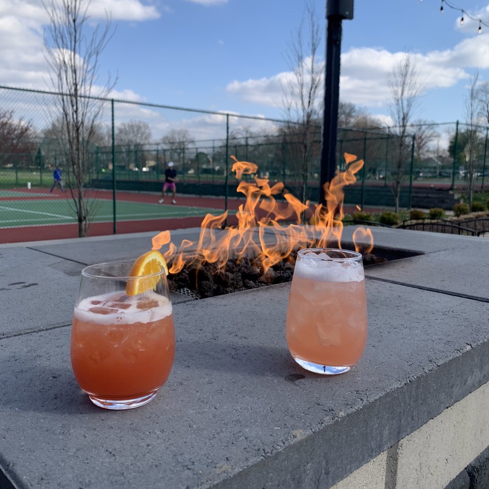 Rockwell Beer Garden - The fire pit and two of their cocktails. - Pizza Near Me - St. Louis, Missouri Rockwell Beer Garden - The fire pit and two of their cocktails. - Pizza Near Me - St. Louis, Missouri
