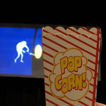 Palace Theatre - a person holding a popcorn box in front of a television - Cinema Near Me - Gallatin, Tennessee Palace Theatre - a person holding a popcorn box in front of a television - Cinema Near Me - Gallatin, Tennessee