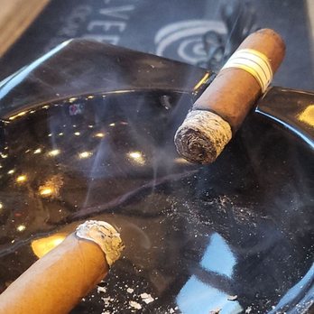 Silver Leaf Cigar Lounge - two cigars on a black ashtray - Lounges Near Me - Fort Worth, Texas Silver Leaf Cigar Lounge - two cigars on a black ashtray - Lounges Near Me - Fort Worth, Texas