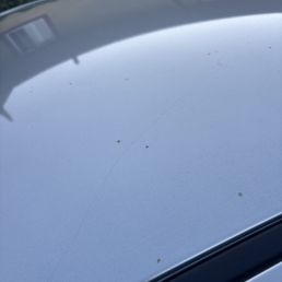 Roof of car, soap not washed off and dirt remains. Roof of car, soap not washed off and dirt remains.