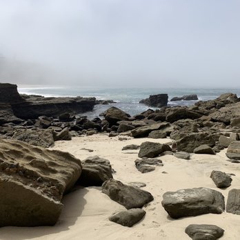 Three Arch Bay - Low tide after walking through the arches to the back side.  Tide pools often on the rock face on the left. - Beaches Near Me - Laguna Beach, California