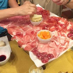 Baratta Salsamenteria Storica - Our meat tray served with fruit & cheese -- delicious!  Note the bowl of wine.