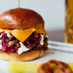 Kracklin - FILTHY P.I.G. - low and slow BBQ pulled pork with American cheese, pickled pink onions, apple slaw, crispy onion & green chili aioli
