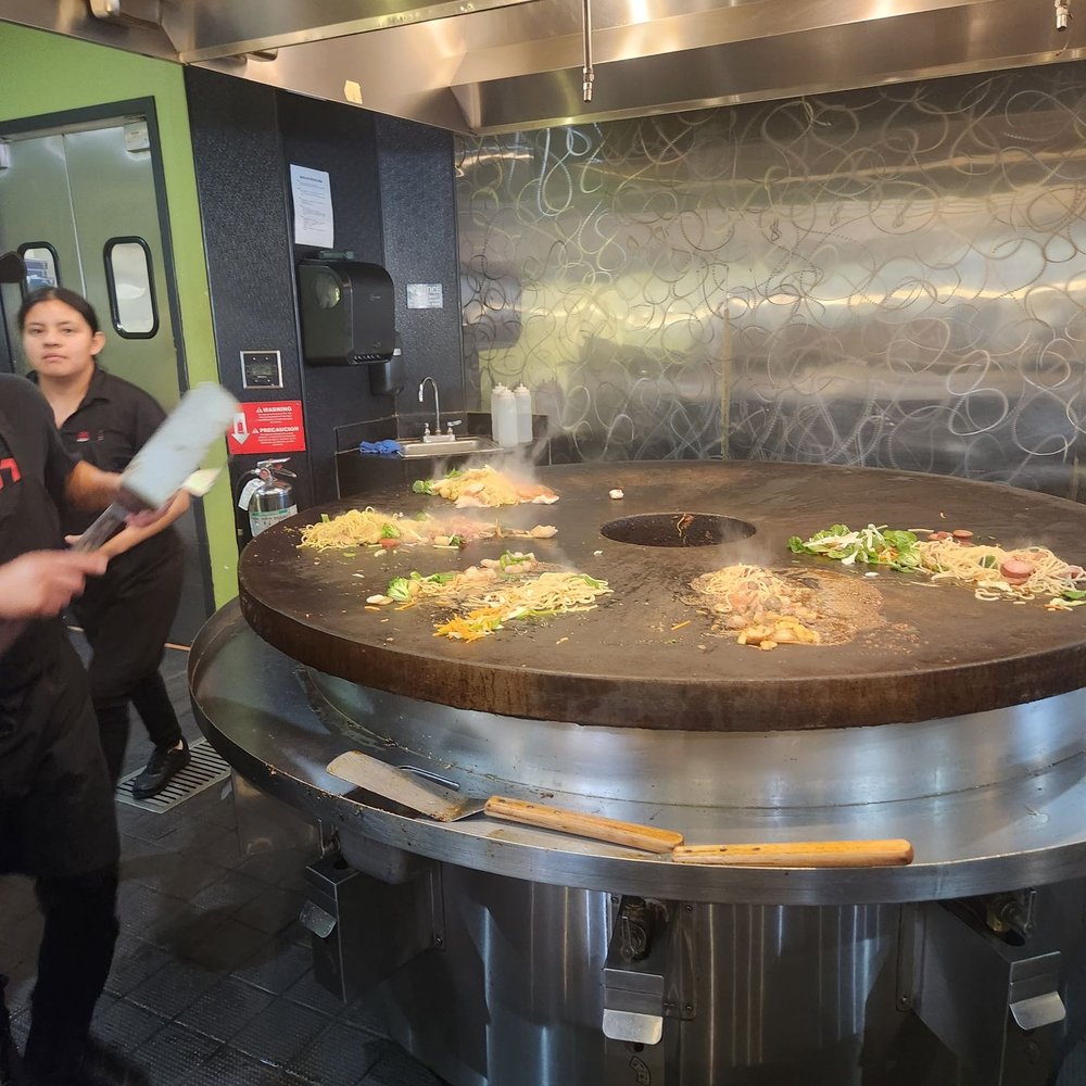 HuHot Mongolian Grill - a man and a woman in a kitchen - Chinese Near Me - Lawrence, Kansas HuHot Mongolian Grill - a man and a woman in a kitchen - Chinese Near Me - Lawrence, Kansas
