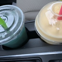 a drink in a plastic cup and a plastic cup with a straw a drink in a plastic cup and a plastic cup with a straw