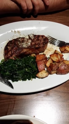 Photo of Paul Martin's American Grill - Mountain View - Mountain View, CA, US. Prime new York steak with sautéed spinach