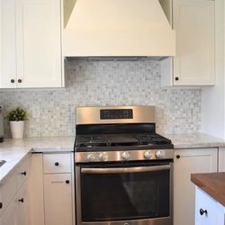 North Bay Homes - New marble countertop, back splash, and custom range hood