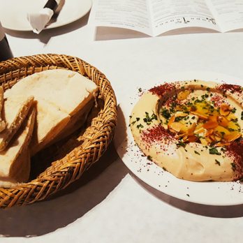 Grape Leaves Restaurant - Hummus with pita triangles ($4). Plated nicely with sliced almonds and olive oil! - Moroccan Near Me - Oak Park, Illinois Grape Leaves Restaurant - Hummus with pita triangles ($4). Plated nicely with sliced almonds and olive oil! - Moroccan Near Me - Oak Park, Illinois
