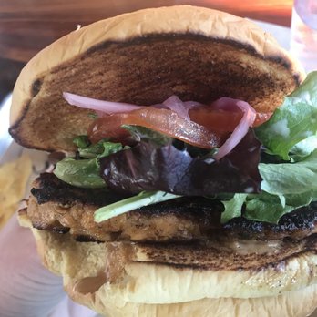 Industry - Smoked salmon burger contains poblano ranch & chipotle aioli which greet you like a lovely warm friendly campfire. Tasty greens, no iceberg! - New American Near Me - San Marcos, Texas Industry - Smoked salmon burger contains poblano ranch & chipotle aioli which greet you like a lovely warm friendly campfire. Tasty greens, no iceberg! - New American Near Me - San Marcos, Texas