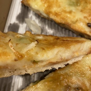 Pizza Bank Restaurant - a close up of a piece of pizza - Pizza Near Me - Kirkland, Washington Pizza Bank Restaurant - a close up of a piece of pizza - Pizza Near Me - Kirkland, Washington
