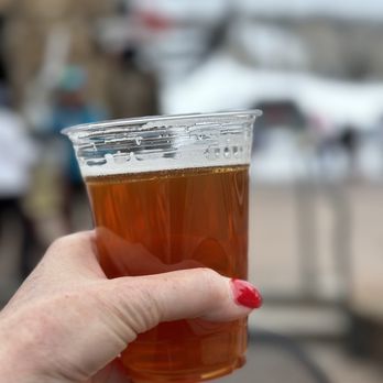Tracks Cafe & Bar - a hand holding a glass of beer - Bars Near Me - Telluride, Colorado Tracks Cafe & Bar - a hand holding a glass of beer - Bars Near Me - Telluride, Colorado