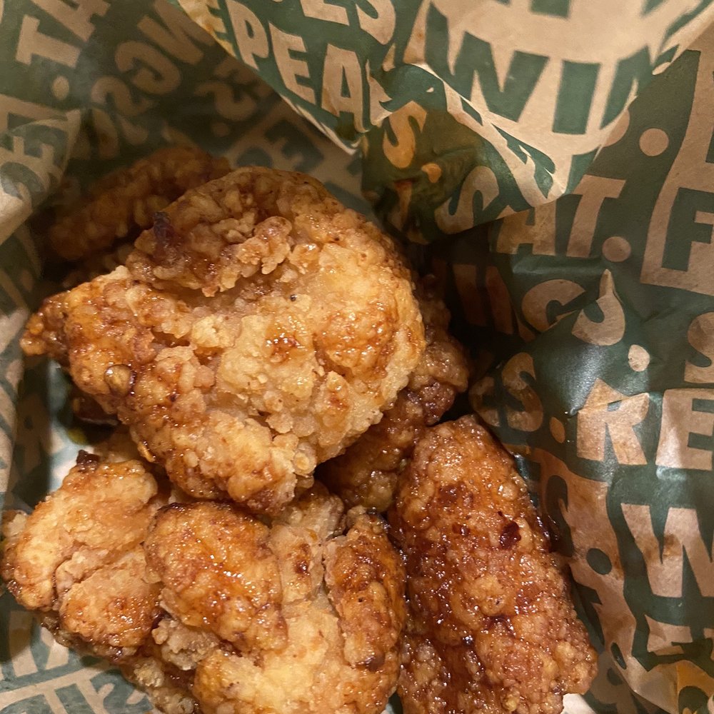 a basket of fried chicken in a paper wrapper a basket of fried chicken in a paper wrapper